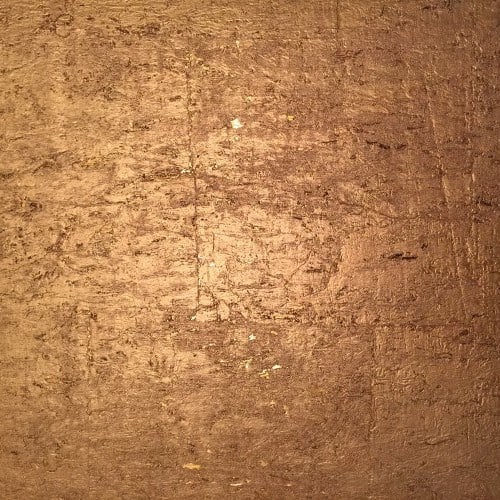 place gold cork wallpaper under a chair rail on gallery walls