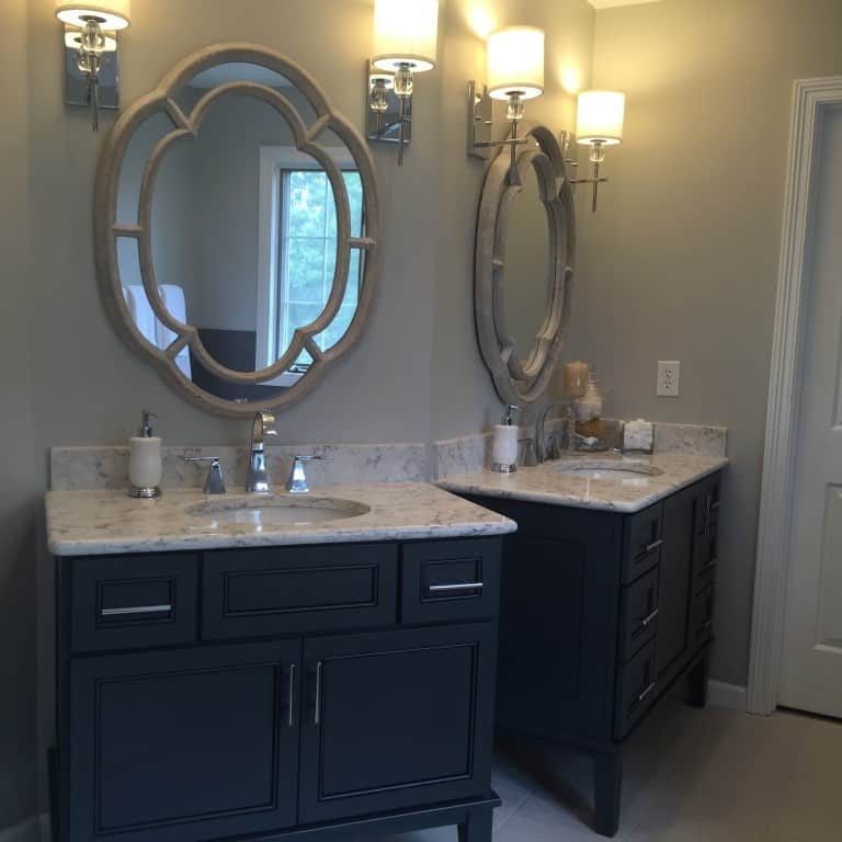 the odd angle of the original vanities left the homeowner with unusable and awkward corner cabinets that just collected junk. by replacing them with individual furniture pieces, we gave the homeowner much more functional storage and saved them money by not going the traditional custom cabinetry route.