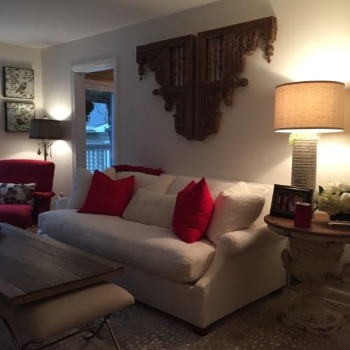 A plush and and inviting off-white sofa sets the tone for Patty’s living room. Accents of red show a glimpse into the bold colors she had used in her previous home. Using lighter colors and soft wood tones allow for this cottage home to feel relaxing but still sophisticated