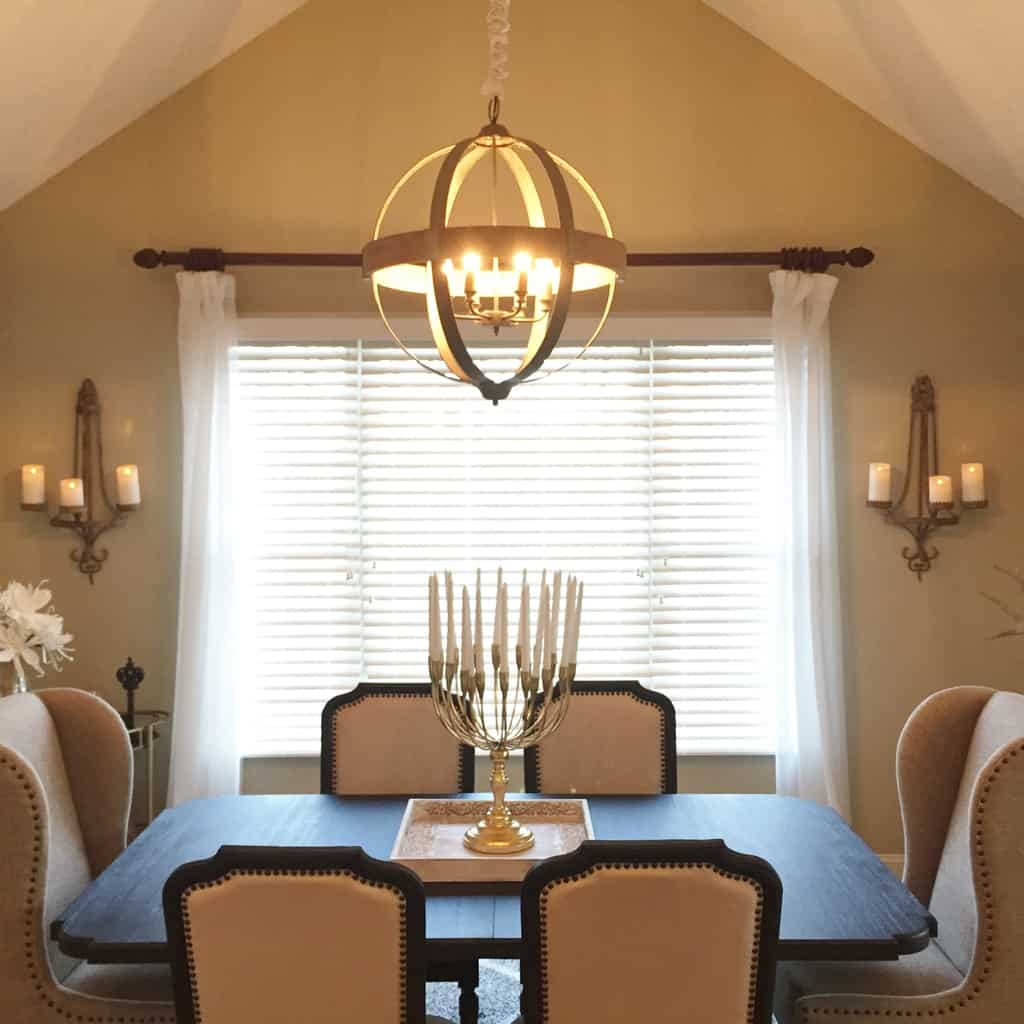 The chandelier hangs in the dining room over a gold-plated candelabra with 20 arms. Sconces were placed on each side of the window to bring more touches of candlelight to the dining setting