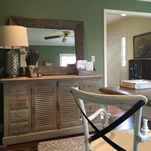 A rustic-chic mirror complements the new sage green wall color and the louvered cabinet gives Becky all of the storage solutions she needed in her new office