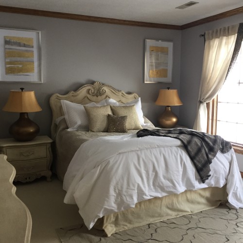 Layering in new linens and a rug in neutral and metallic finishes creates an inviting oasis that any treasured guest of this client would love