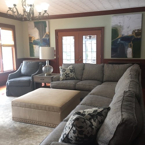 The biggest need in the Haddox family room was seating. With eight people in their family, a sectional was clearly the answer and with all of their young children, a textured fabric with blue, tan, gold, and grey thread to easily disguise wear