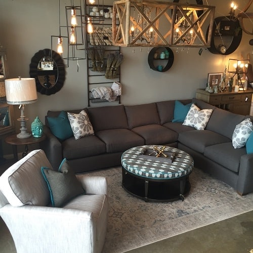 The sectional for the Lilly home needed to be soft and comfortable but stand up to everyday use and their pets. A beautiful charcoal fabric on the body of a transitional style like Brynne with pops of color and pattern make this sofa perfect for their family room