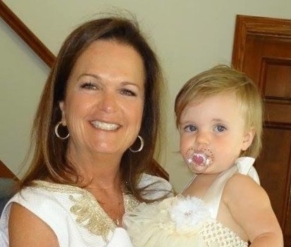 The original Yeager Design & Interiors, Anita Yeager, holds her youngest grandchild, Ivery Cross