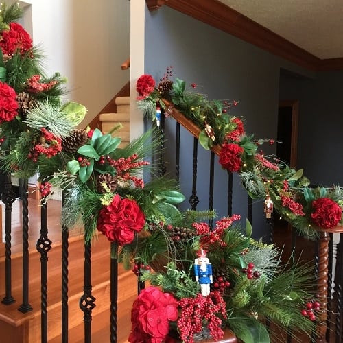 If you're less than thrilled about a catalog or online purchase when it comes in, just add in fillers for a more finished and personalized look. We used this garland purchased online and wired in red sparkle hydrangeas and tucked in little toy soldier ornments for the kids to enjoy.